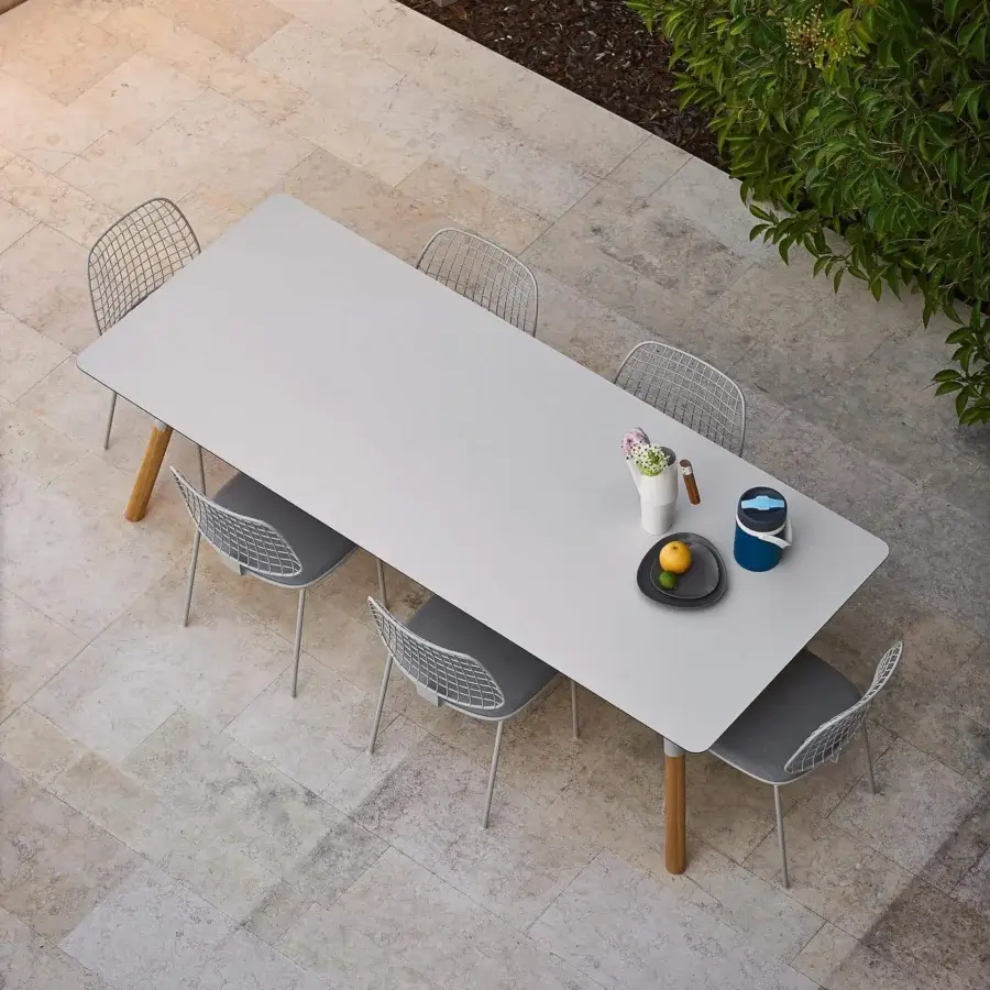 Distinguished Varaschin Link table crafted in Italy with a smooth light gray ceramic top and light-toned teak wood legs