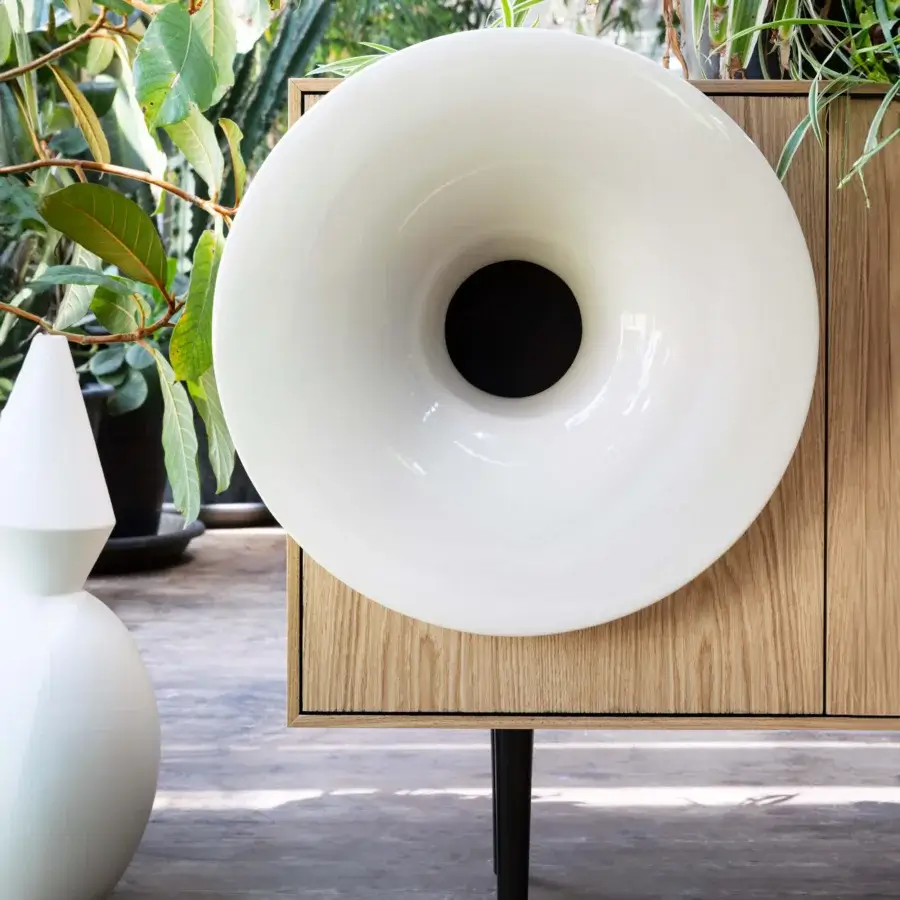 Distinctive Miniforms Caruso bar cabinet in light-toned wood with sleek black legs and white horn-shaped speaker