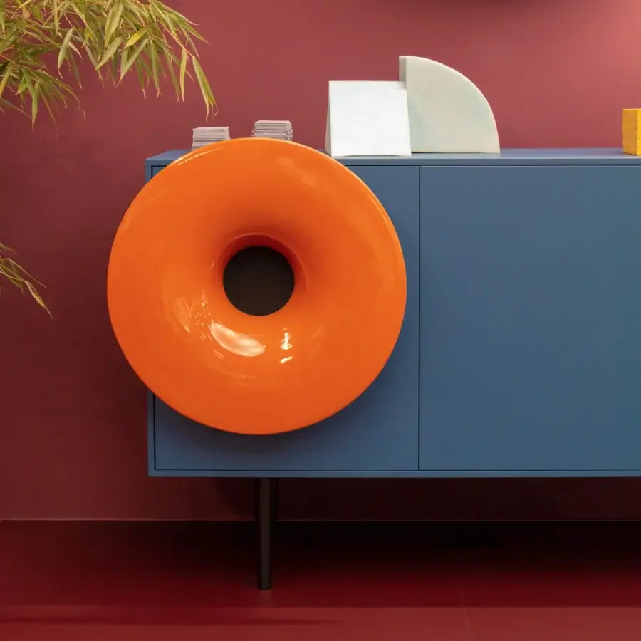 Distinctive Miniforms Caruso bar cabinet in muted blue matte wood with vibrant orange speaker integration