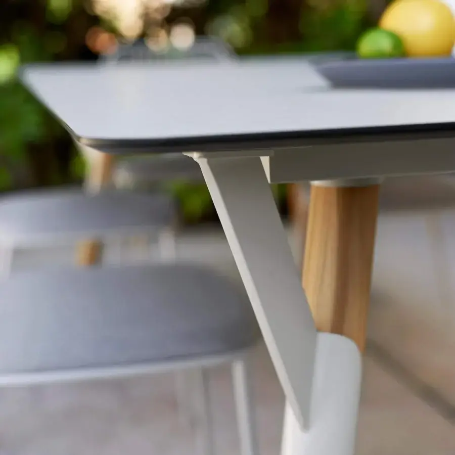 Exceptional Varaschin Link table crafted in Italy with a light gray matte top and cylindrical wooden legs