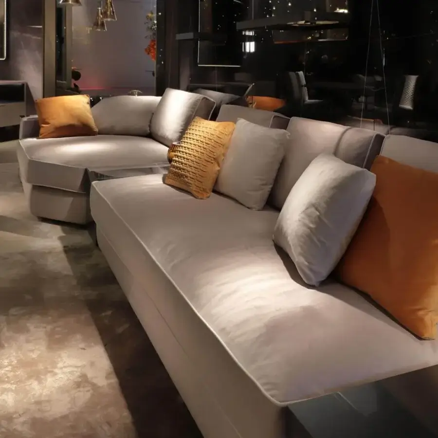 Distinguished Reflex Adone sectional upholstered in light gray fabric with a curved silhouette and plush cushions
