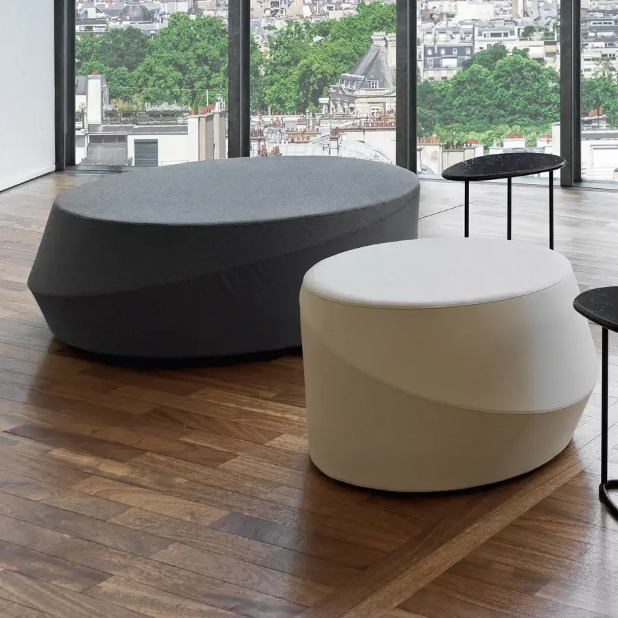 Exclusive Casamania Giro ottoman with smooth contemporary design upholstered in light beige premium fabric exhibiting horizontal seam detail