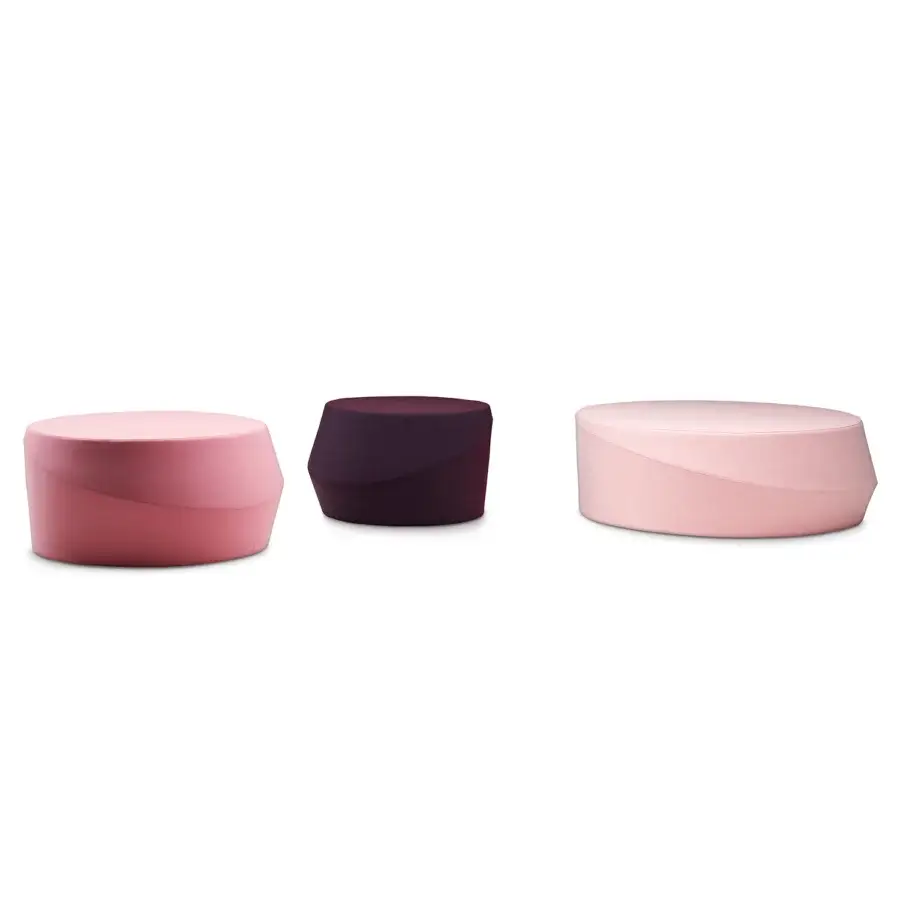 Elegant Casamania Giro ottoman presents a cylindrical form fully upholstered in light pink premium textile with a smooth finish