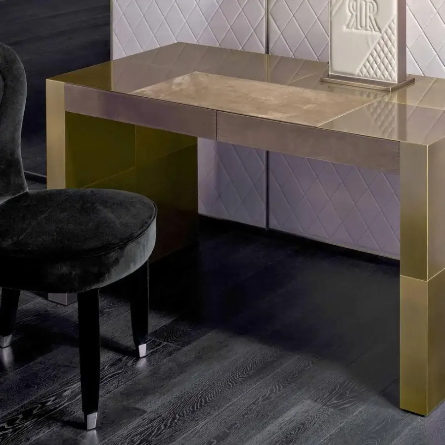 Superior Rugiano Florida Lux desk with neutral suede-like leather and reflective golden-toned metal in bronze or steel