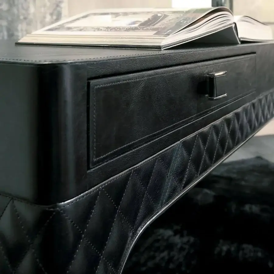 Distinguished Rugiano Coline desk with black leather cover and sleek steel metal details exhibiting matelassé embroidery