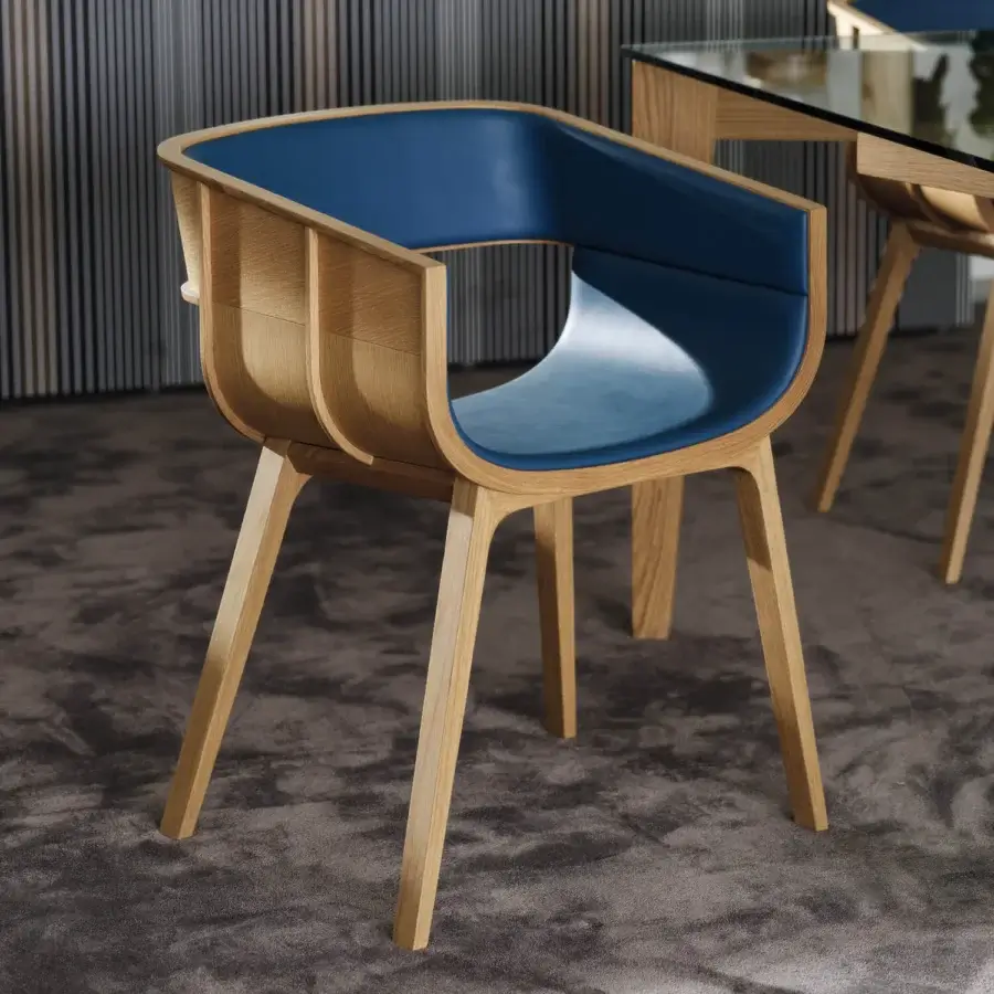 Superior Casamania Maritime armchair crafted in solid oak with medium shade blue upholstery and curved silhouette