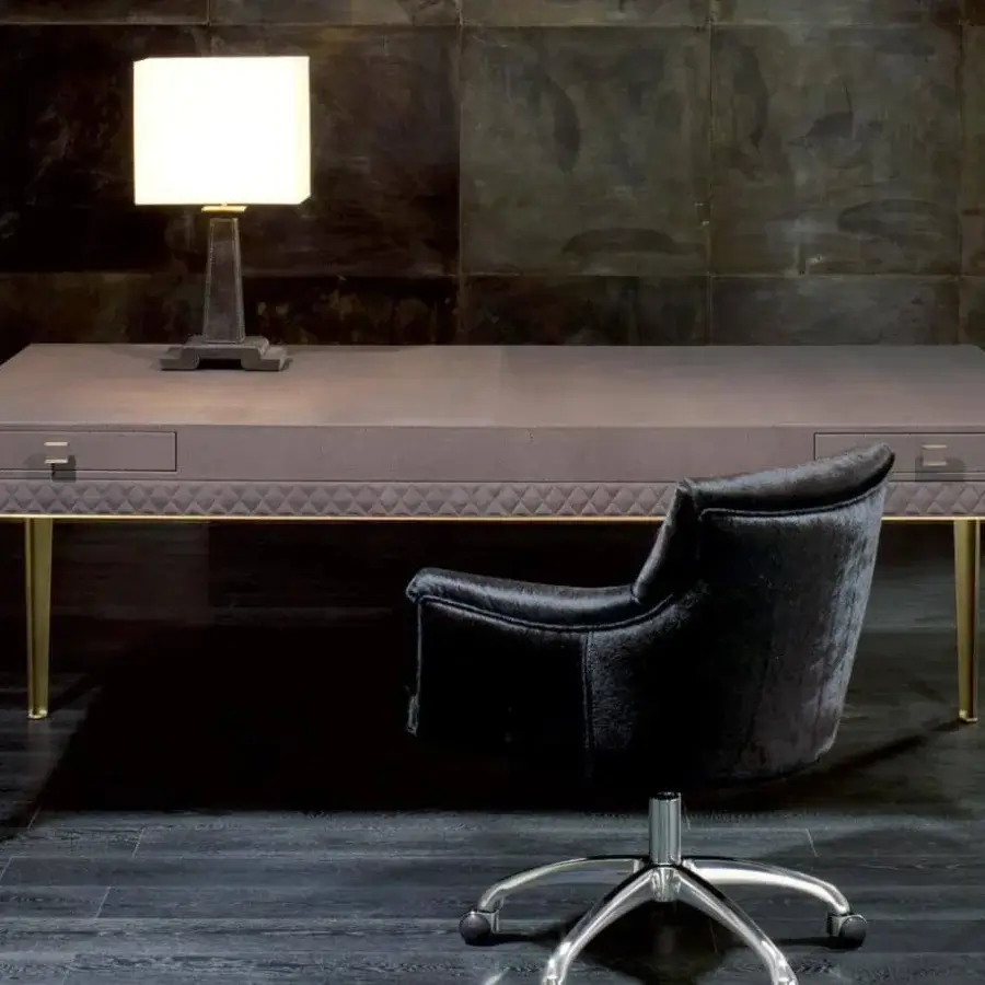 Sophisticated Rugiano Coline desk with muted gray-brown leather cover and refined matelassé embroidery built with gold-toned steel details