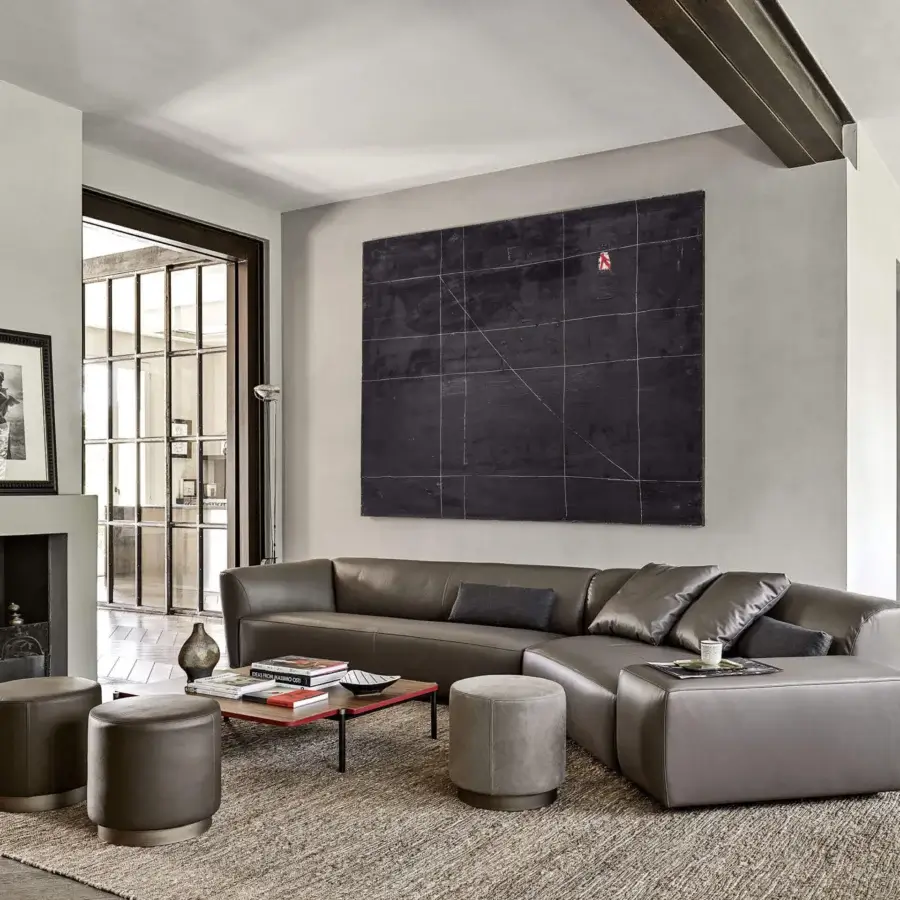 Exceptional Frag Clubby ottoman upholstered in matte gray-brown leather with a subtly recessed dark metallic base