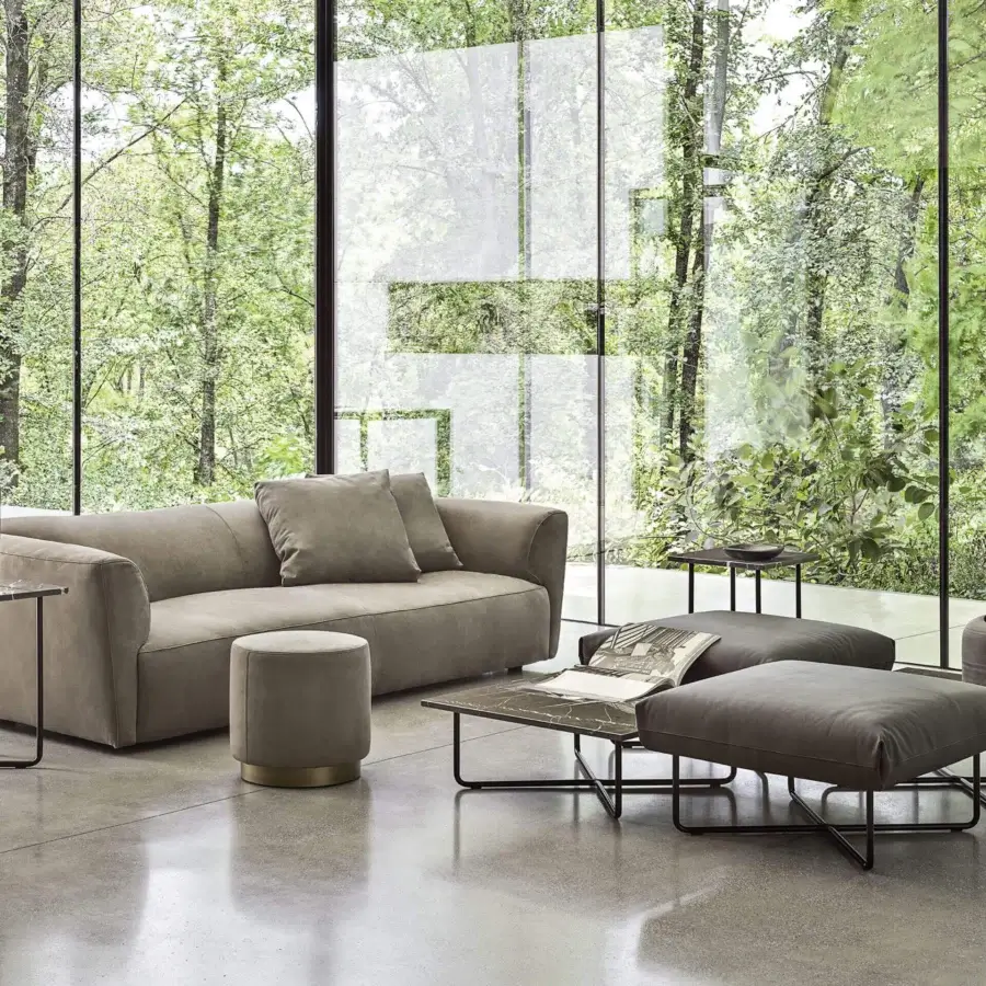 Elegant Frag Clubby ottoman crafted in Italy with smooth neutral textile upholstery and glossy metallic banding