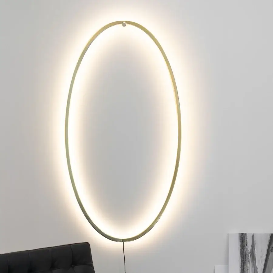 Exceptional Nemo Lighting Ellisse wall lamp crafted in Italy with a tall oval metal frame and smooth matte brass finish