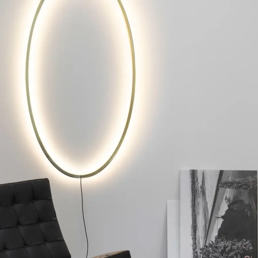 Innovative Nemo Lighting Ellisse wall lamp crafted in Italy with an elliptical form and matte gold toned finish