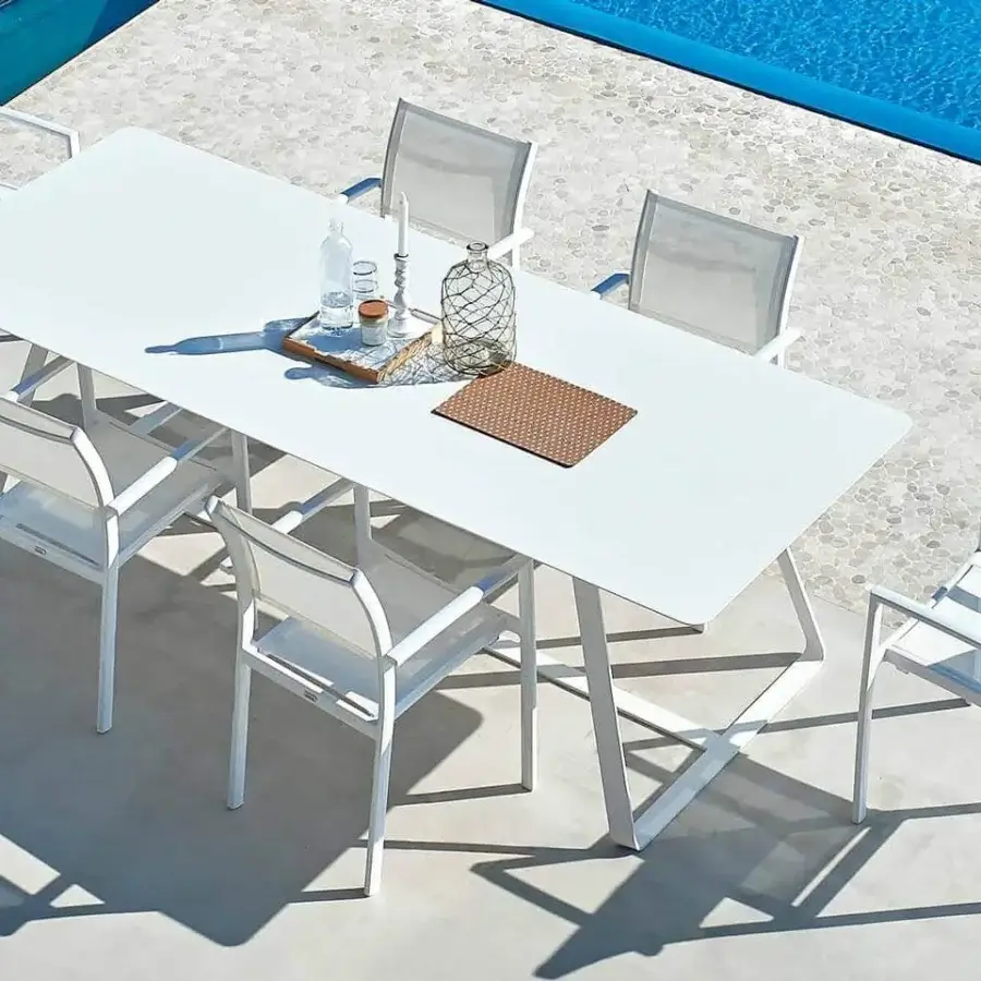 Elegant Varaschin Kolonaki table with white powder-coated flat steel structure and rectangular HPL top