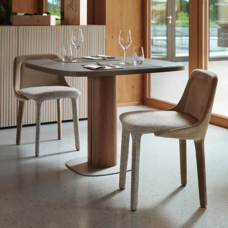 Distinguished Casamania Lepel chair upholstered in premium fabric with patterned legs and light beige matte finish