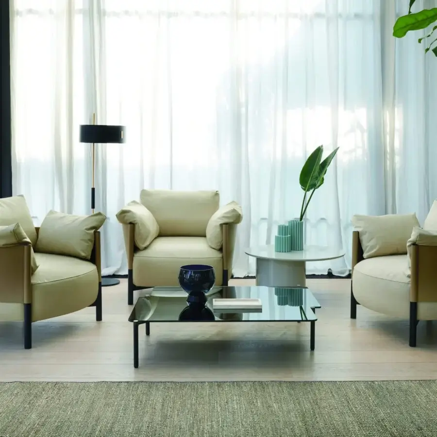 Superior Frag Syren lounge chair with a tubular metal frame and plush tan leather supporting beige textile cushions