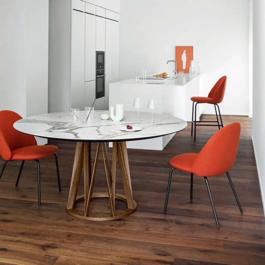 Exclusive Miniforms Iola chair with expanded polyurethane shell upholstered in textured matte orange textile and dark metal legs