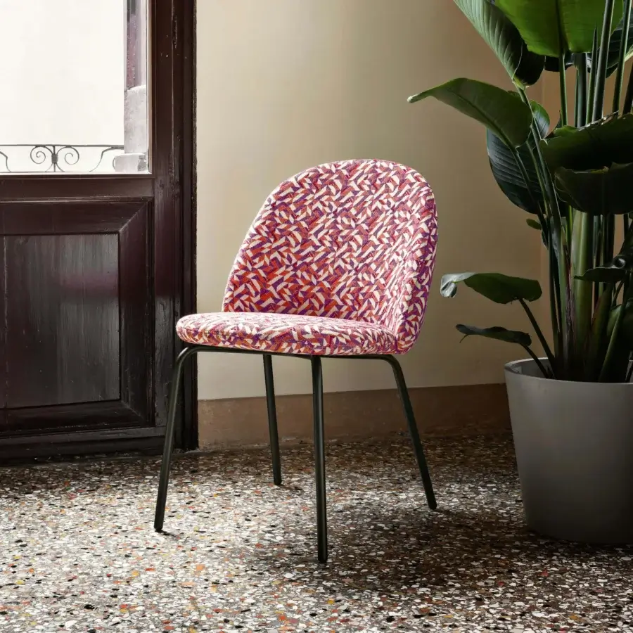 Exceptional Miniforms Iola chair with expanded polyurethane shell and vibrant geometric patterned upholstery in orange, red, purple and white