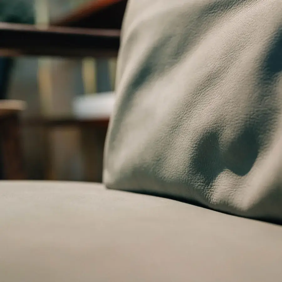 Distinguished Borzalino Lisa lounge chair in neutral textile upholstery with lacquered oak and waxed leather detailing