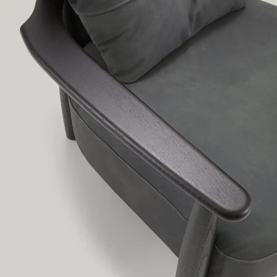 Sophisticated Borzalino Lisa lounge chair with dark gray fabric upholstery and lacquered oak structure with waxed leather straps