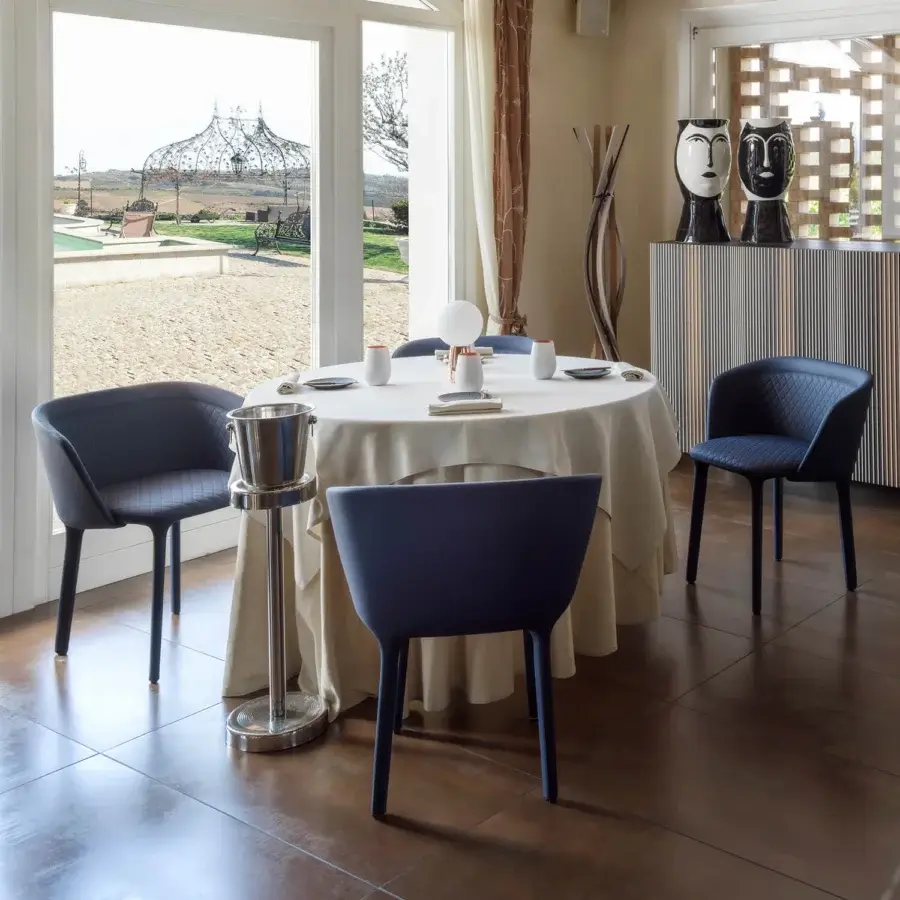 Elegant Casamania Lepel armchair fully upholstered in deep blue fabric with simple black legs