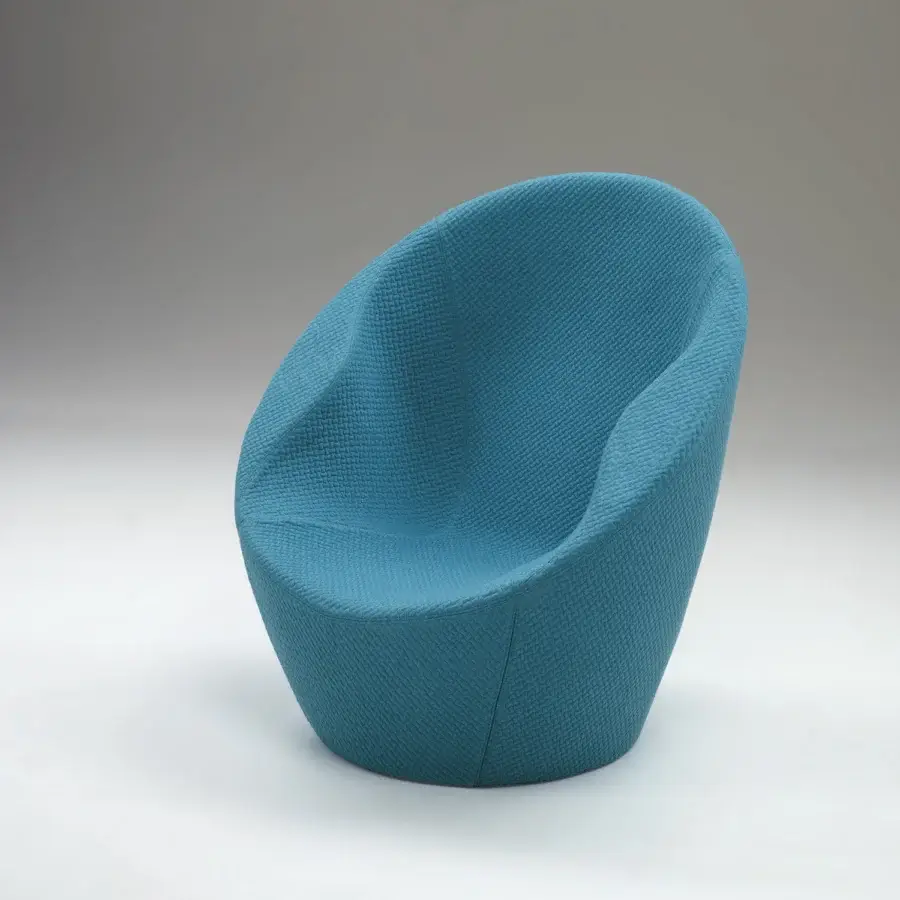 Exclusive Casamania Ouch lounge chair presents a voluptuous silhouette upholstered in textured medium blue woven textile crafted with a metal structure
