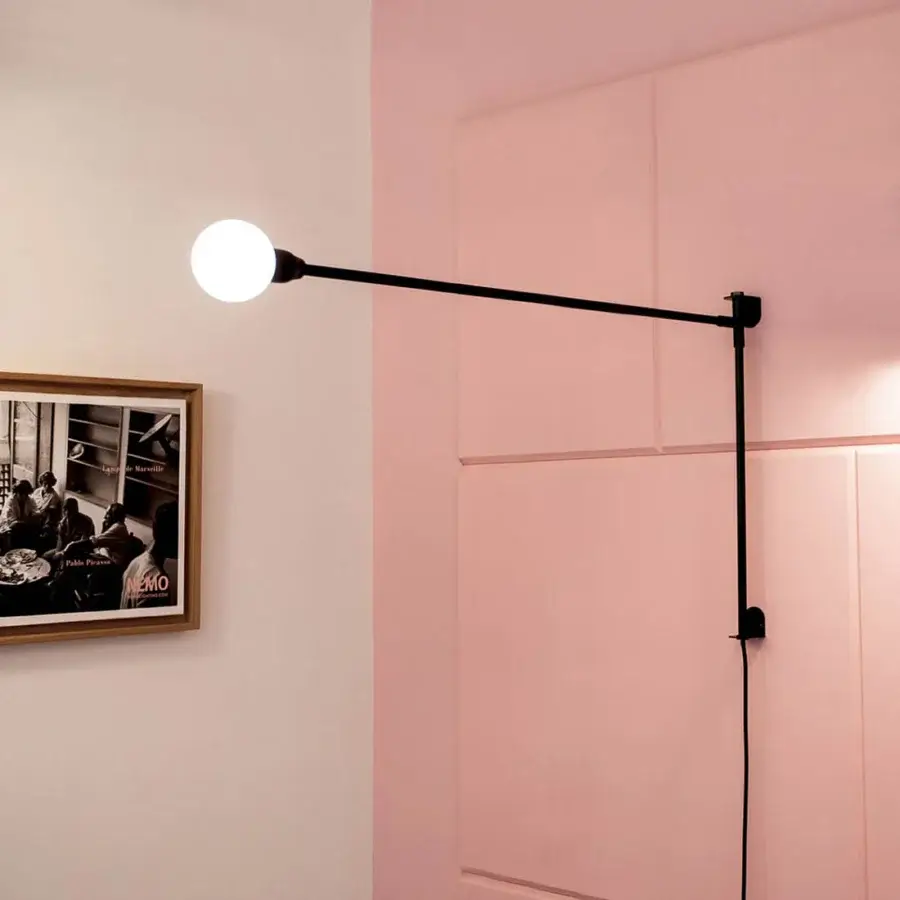 Elegant Nemo Lighting Potence Pivotante wall lamp crafted in black tubular steel with a matte finish and exposed white bulb