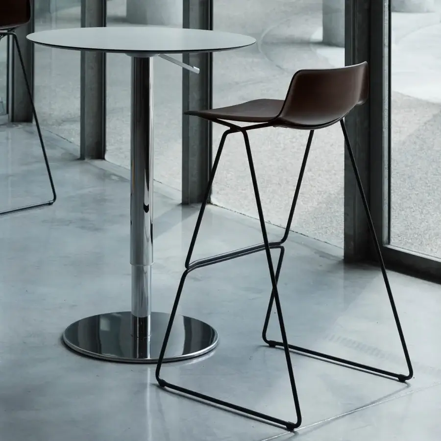 Innovative Casamania Pressious stool crafted from plywood beech with smooth brown seat and sleek black metal sleigh base