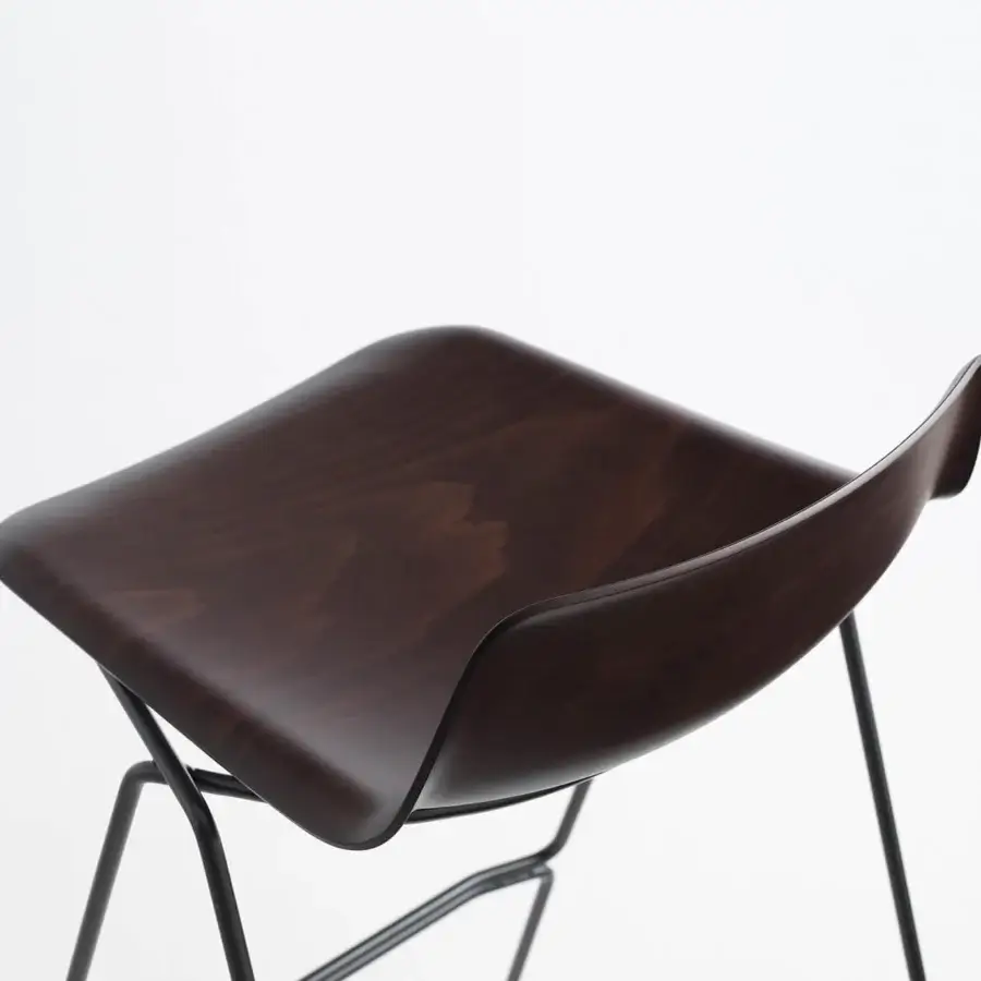 Avant-garde Casamania Pressious stool built with dark-stained plywood beech and sleek dark metal sleigh legs
