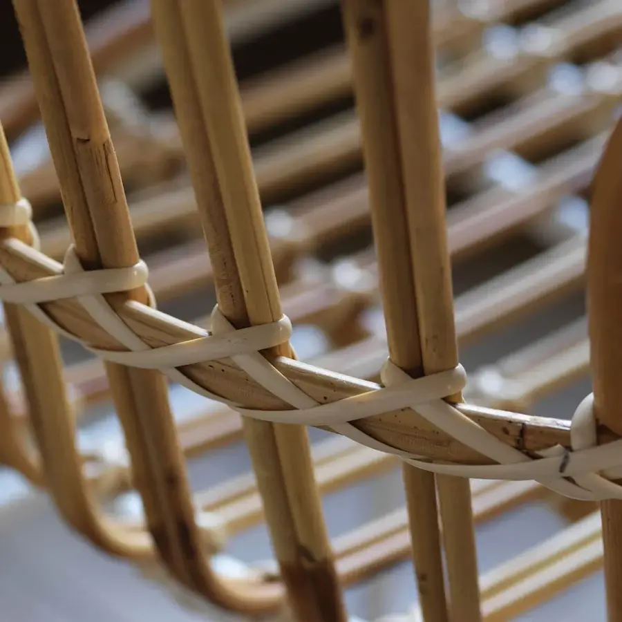 Distinguished Casamania Raphia armchair built in woven rattan with light brown natural wood and off-white synthetic bindings