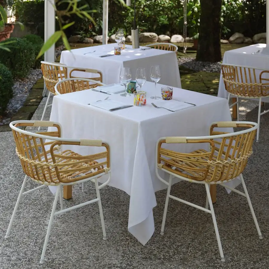 Superior Casamania Raphia armchair crafted in woven light tan rattan with a clean white metal frame