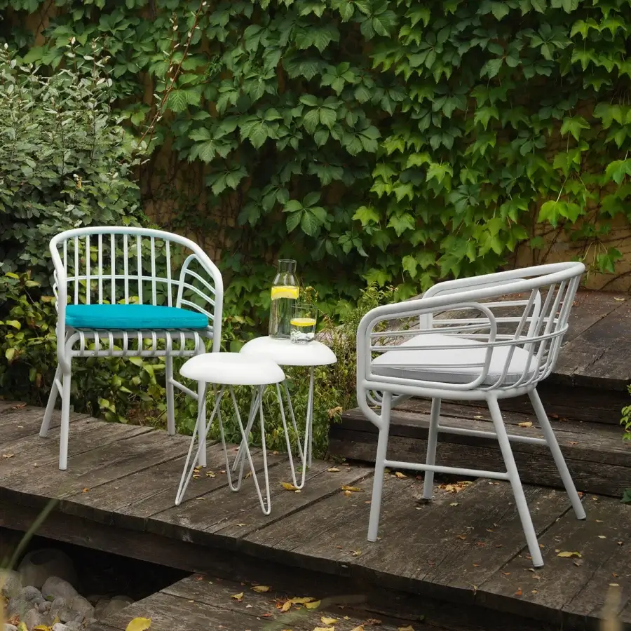 Distinguished Casamania Raphia armchair with curved silhouette and plush gray cushioned seat in painted aluminum