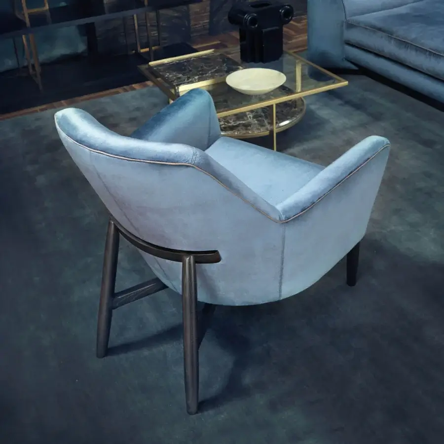 Elegant Borzalino Eve Plus lounge chair with light blue textile upholstery and lacquered oak base