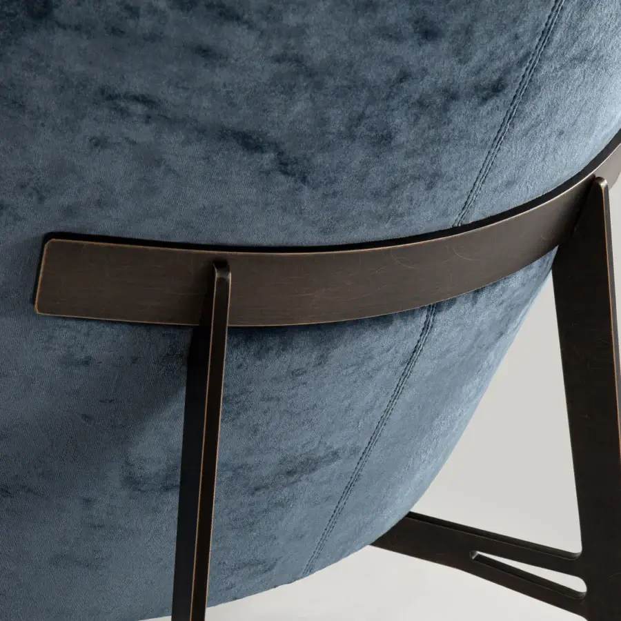 Distinguished Borzalino Eve Plus lounge chair with curved frame upholstered in deep blue textile and lacquered oak base