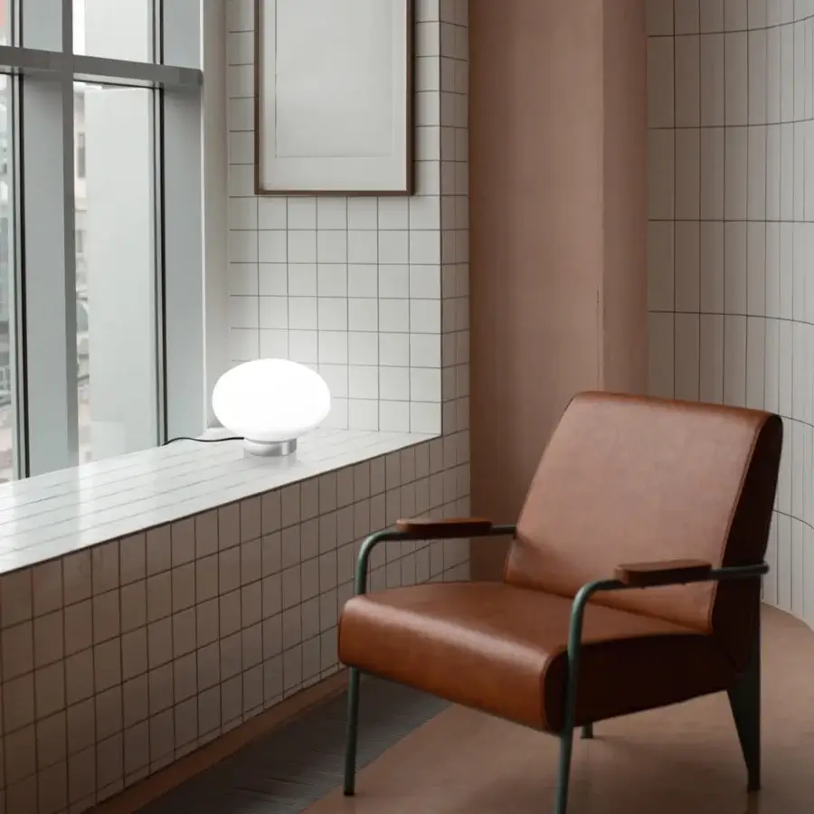 Exceptional Nemo Lighting Maga lamp with an elliptical opal blown glass sphere and sleek light-toned cylindrical base