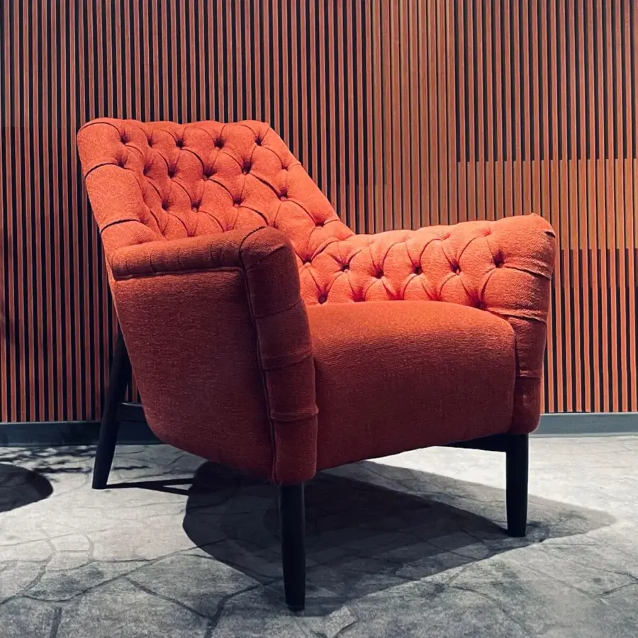 Superior Borzalino Eve Capitonnè lounge chair with warm orange-red textile and lacquered oak base