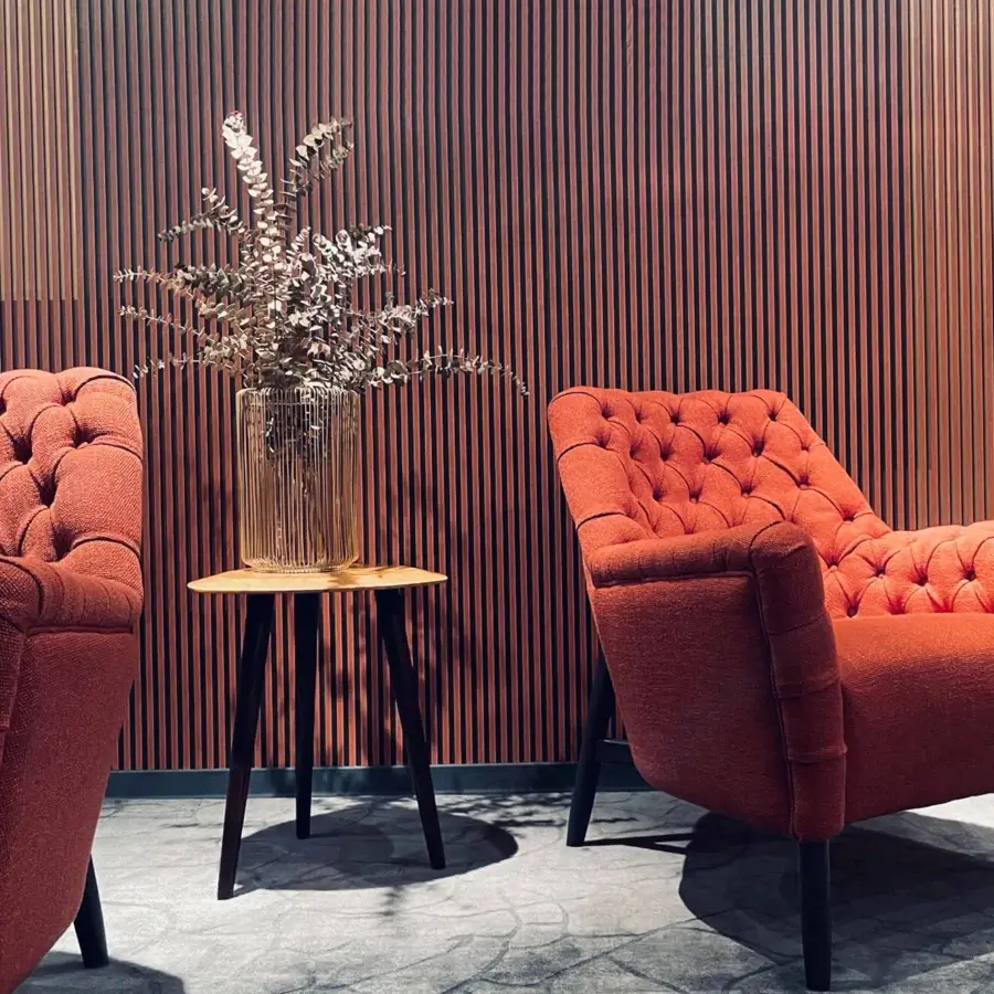 Distinguished Borzalino Eve Capitonnè lounge chair crafted in reddish-orange textile with a lacquered oak base