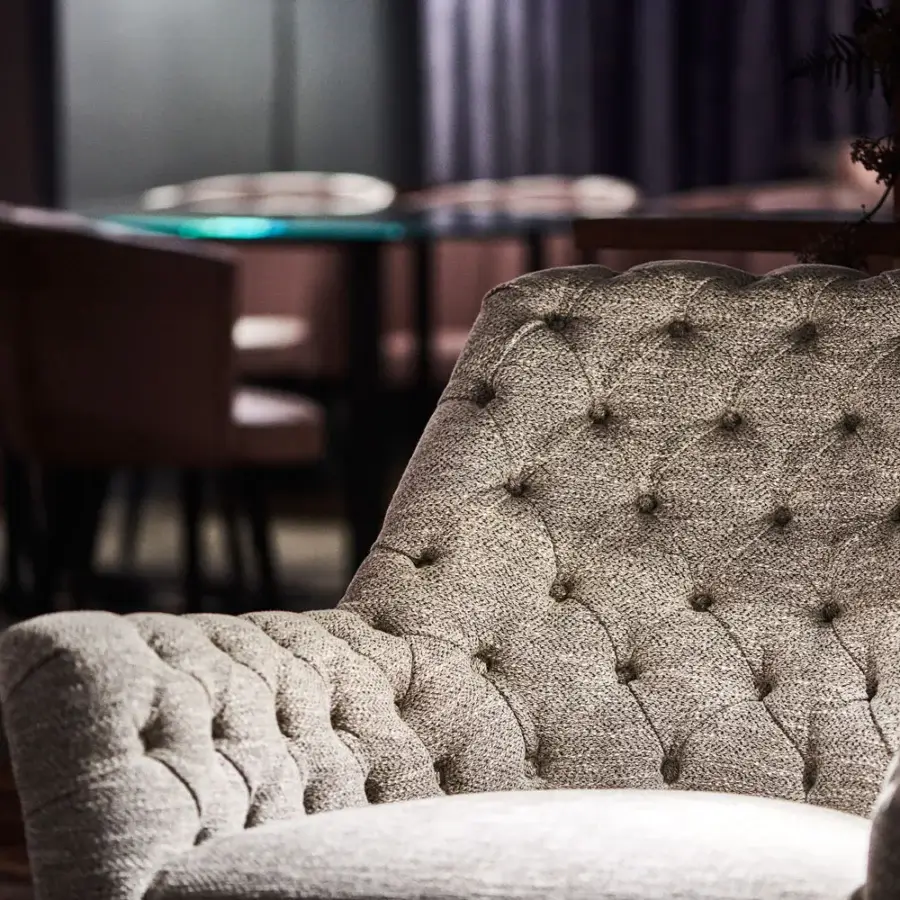 Exclusive Borzalino Eve Capitonnè lounge chair with light warm gray textured fabric and solid walnut Canaletto wood base