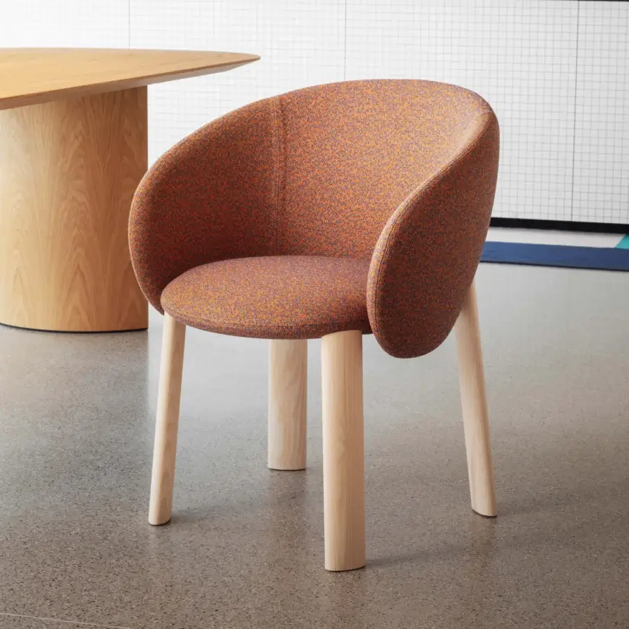 Exceptional Miniforms Nebula Wood chair with enveloping form upholstered in vibrant orange and purple patterned textile with light-toned wooden legs