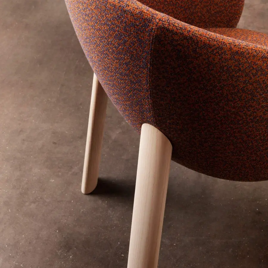Superior Miniforms Nebula Wood chair with enveloping design upholstered in textured orange and darker tones with cylindrical wooden legs