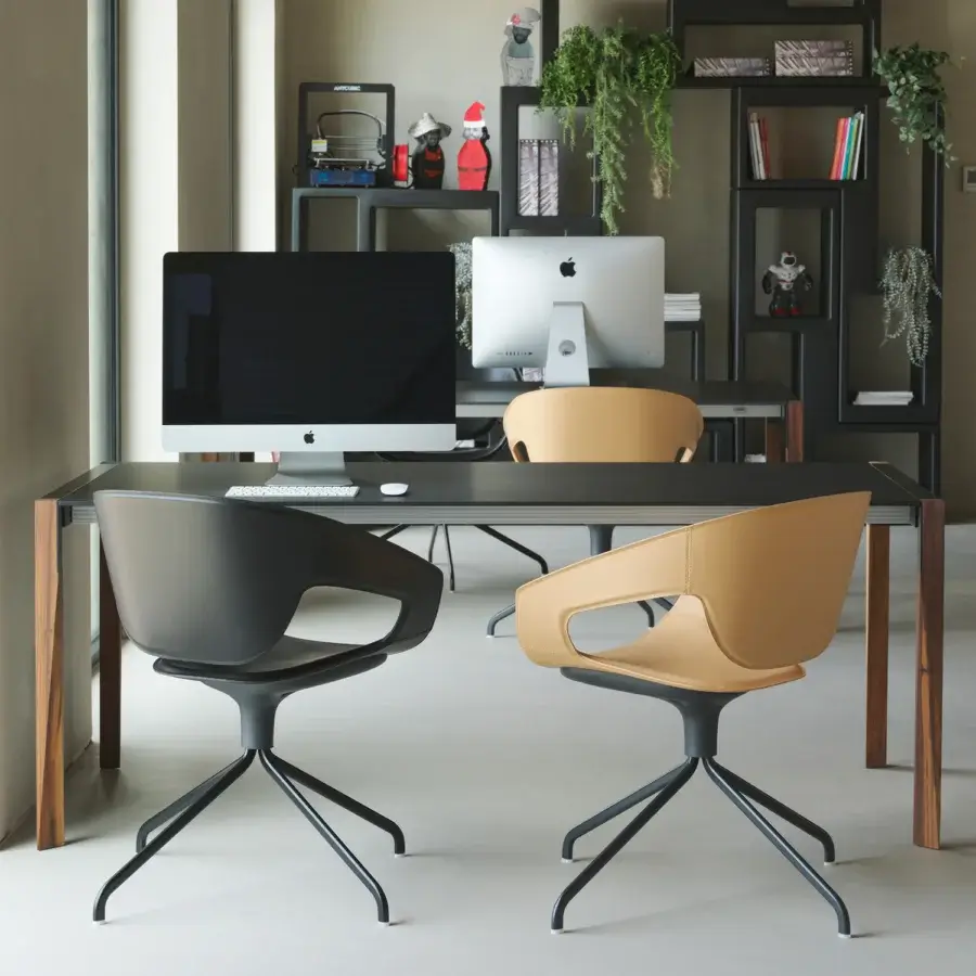 Distinctive Casamania Vad armchair with dark grey hard leather upholstery and a swiveling metal base