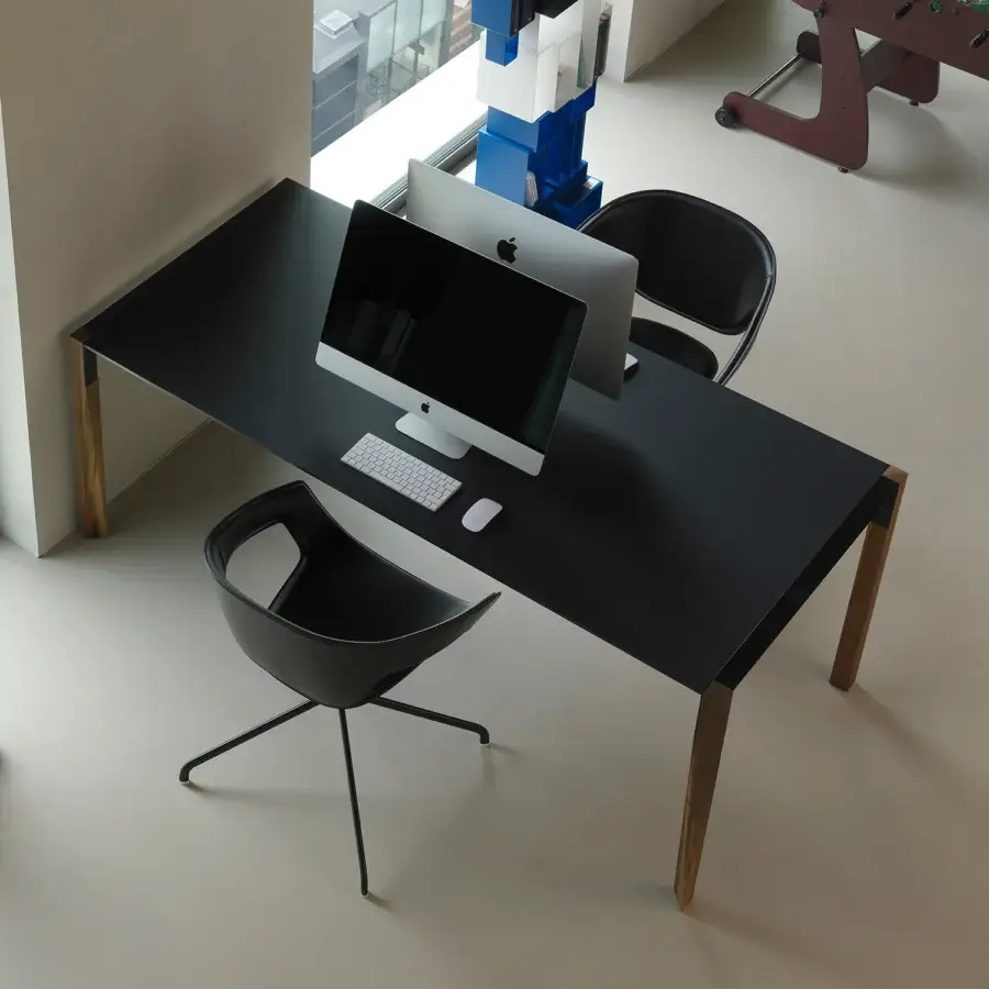 Superior Casamania Vad armchair with injection molded body and sleek metal swiveling base in a uniform black finish