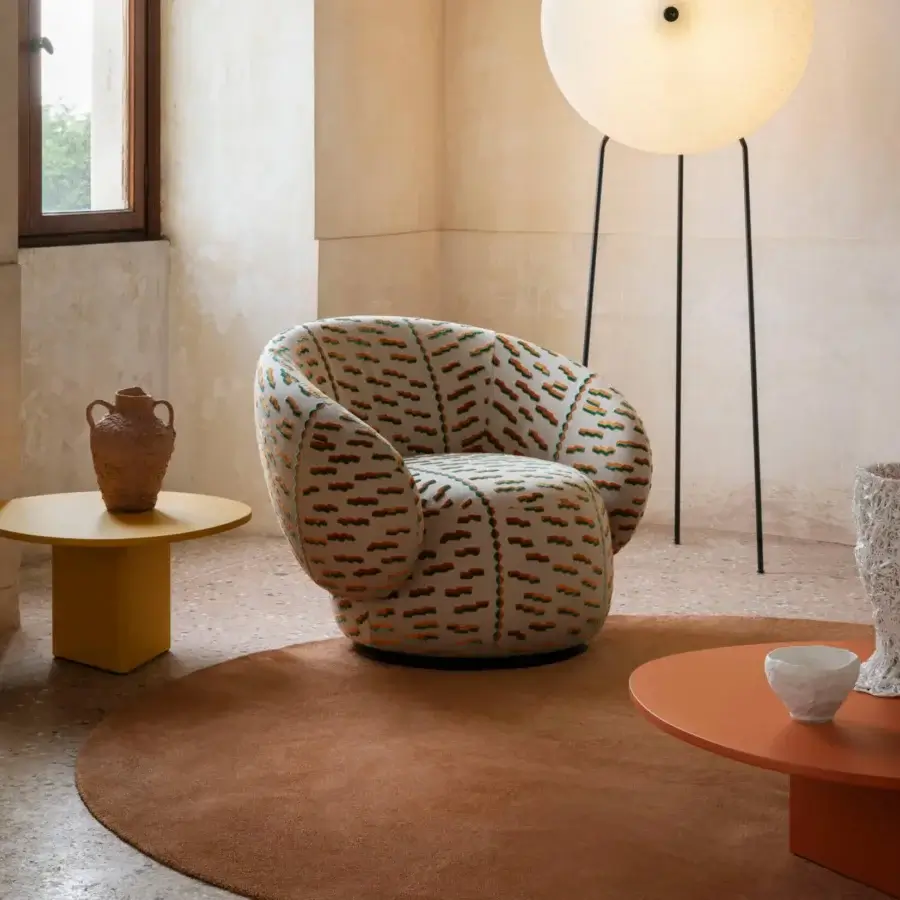 Distinctive Miniforms Nebulona lounge chair with plump seat upholstered in patterned orange and green textile