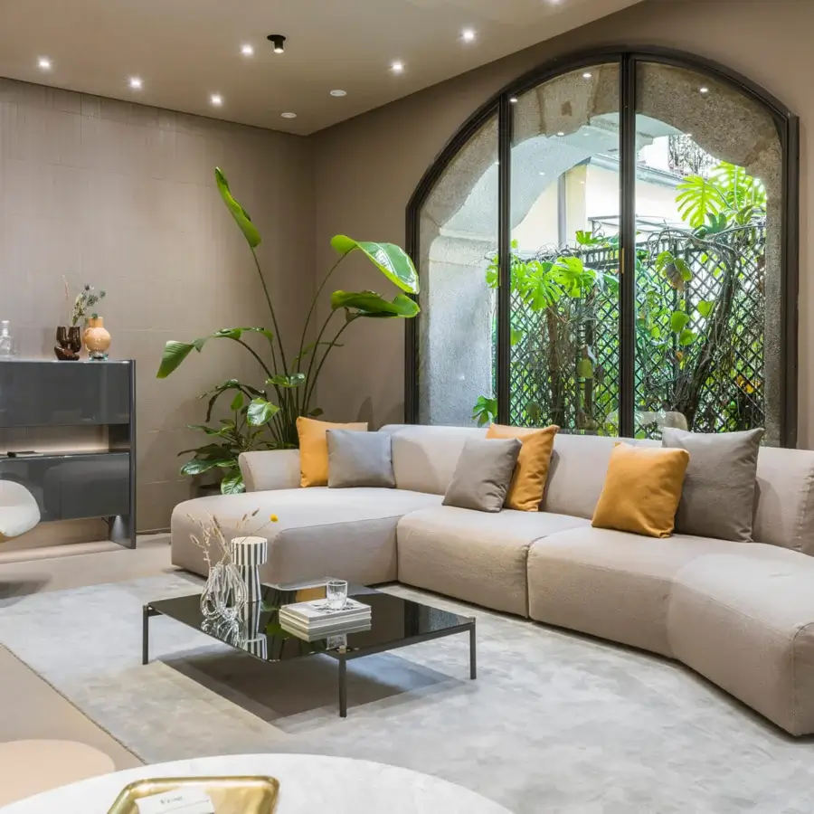 Superior Frag Hug sectional with geometric shapes and welcoming volumes upholstered in light beige textile with gray and mustard accents