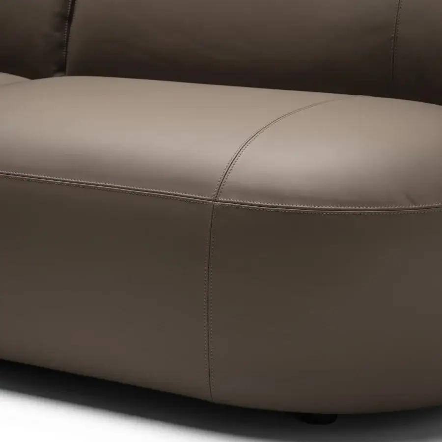 Superior Frag Hug sectional with curved armrests and enveloping backrests upholstered in muted taupe matte textile crafted in Italy