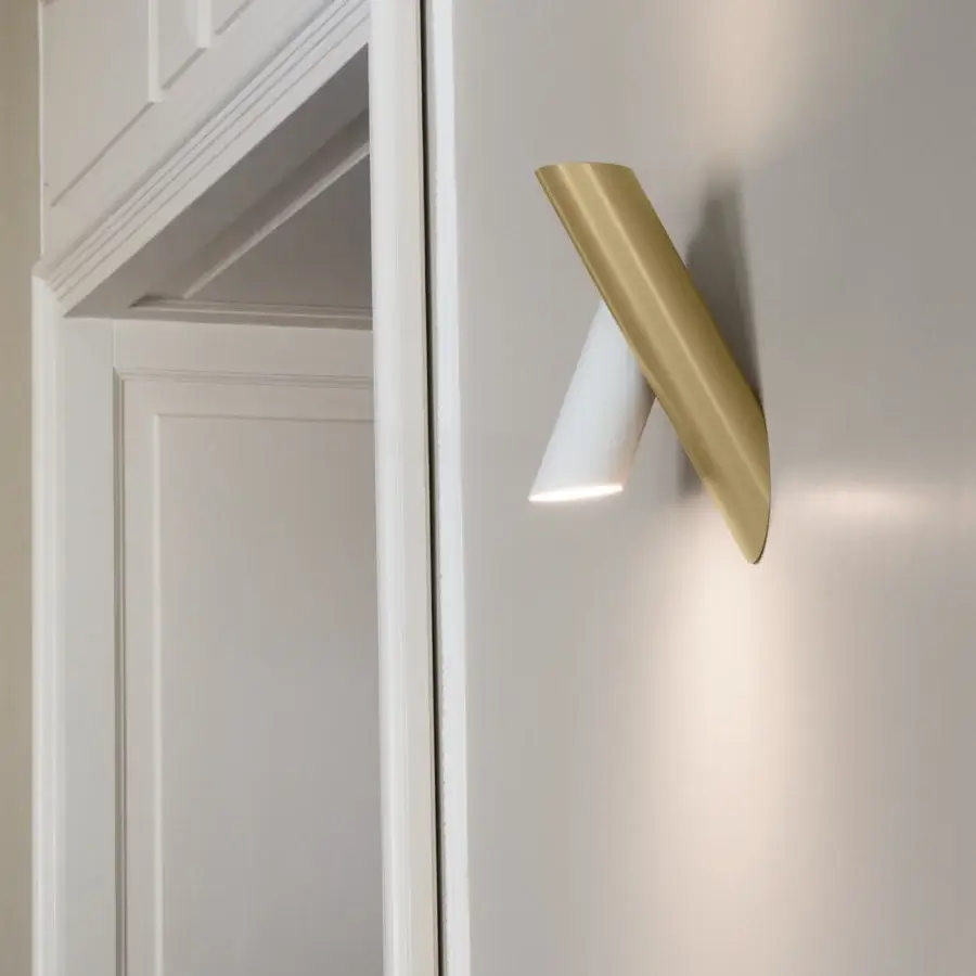 Distinguished Nemo Tubes Wall Lamp crafted in Italy with white cylindrical form and curved gold section with matte finish