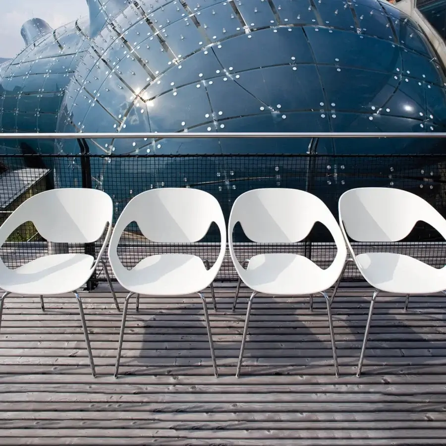 Distinctive Casamania Vad armchair crafted in reinforced polypropylene with smooth matte white finish and cylindrical metal legs