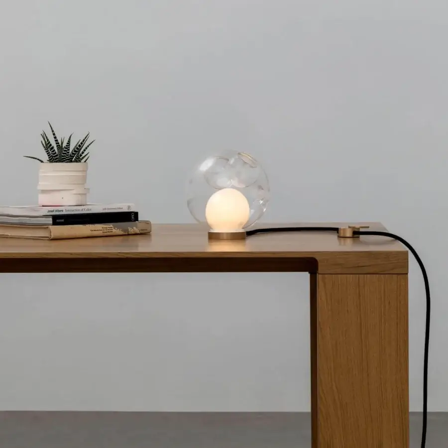 Distinguished Bocci 28 table lamp with transparent hand-blown glass and sleek cylindrical brass base illuminated by an opaque white sphere