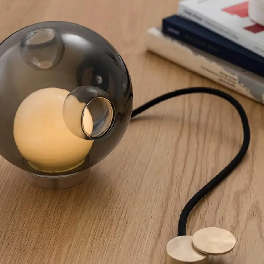 Exceptional Bocci 28 table lamp with smoky gray blown glass shade and metal base built with black textile cord detailing