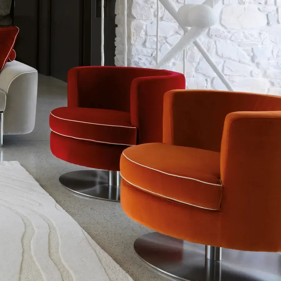 Exclusive Borzalino Frisbee lounge chair with red-orange textile upholstery and polished metal swivel base
