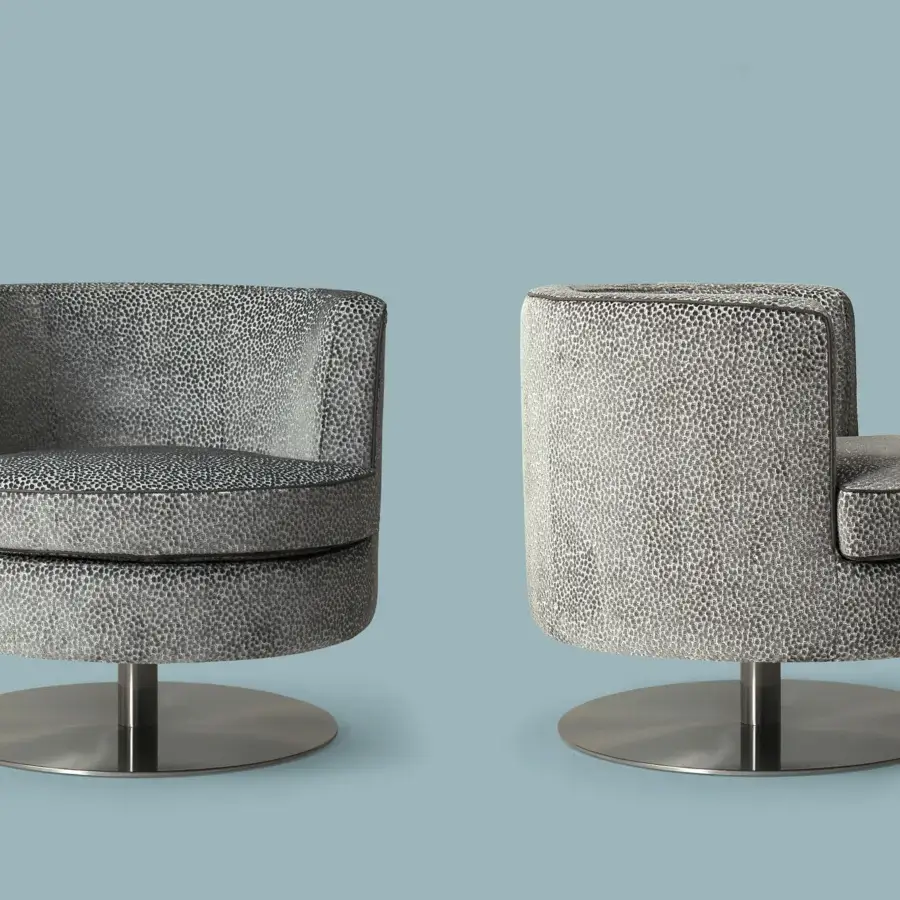 Superior Borzalino Frisbee lounge chair in spotted gray and white fabric with a brushed metal swivel base