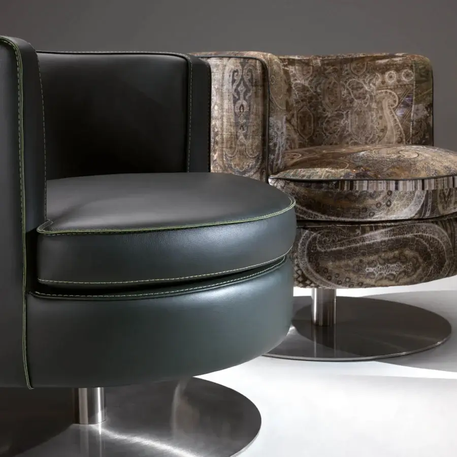 Distinctive Borzalino Frisbee lounge chair with smooth black leather upholstery and bright green stitching detail built with a sleek metal swivel base